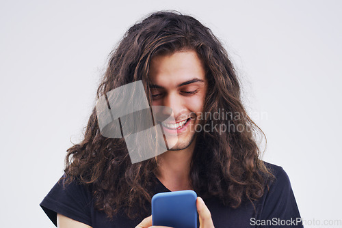 Image of Phone, happy and man typing online in studio with smile for social media, internet and chatting. Communication mockup, white background and male person on smartphone for website, mobile app and text