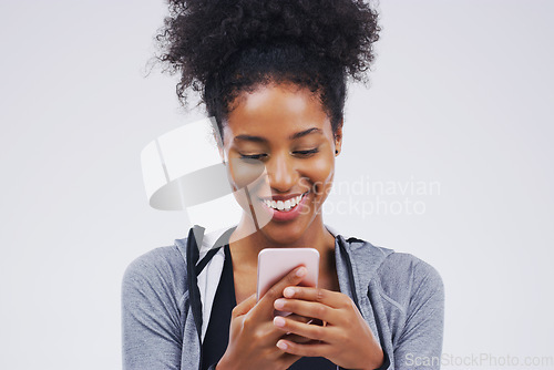 Image of Phone, happy and African woman typing in studio with smile for social media, internet and online chat. Communication, white background and female person on smartphone for website, mobile app and text