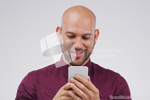 Image of Phone, typing and man in studio with smile for social media, internet and online chat. Communication, white background and happy male person on smartphone for website, mobile app and text message