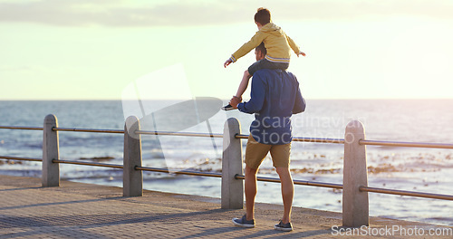 Image of Father, child and piggyback by the beach in sunset for family bonding, playing or fun holiday or weekend in nature. Dad carrying kid on back walking by ocean coast for summer time together outdoors