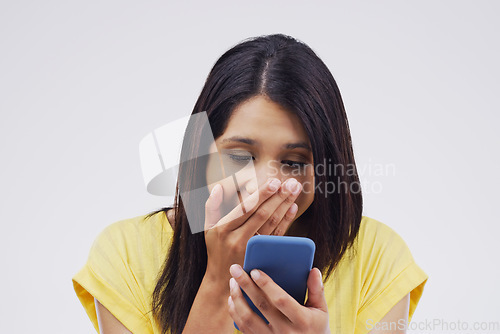 Image of Woman, surprise and phone for prize, good news or winner against a white studio background. Shocked, surprised or excited female person reading on mobile smartphone for lottery winning, wow or bonus