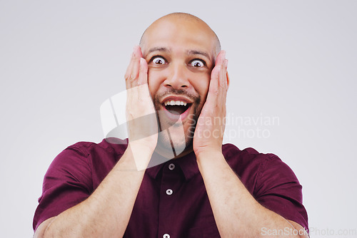 Image of Shock, surprise and portrait of a man in studio with excited, wow or omg facial expression. Happy, smile and face of male model with good news, success or achievement to celebrate by gray background.