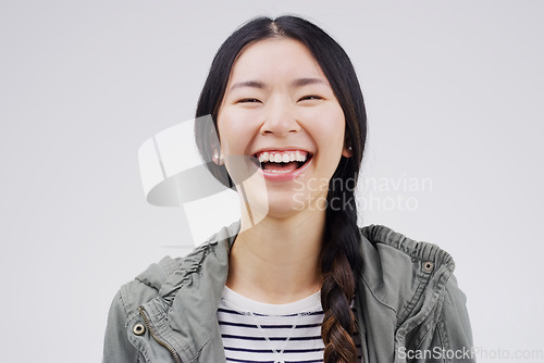 Image of Thats hilarious. Female youth, laugh and face with happiness with studio with freedom and positivity. Woman, student and funny with portrait, free with cheerful mood with smile in casual clothes.