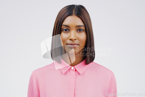 Image of Portrait, serious and hair with an indian woman in studio on a gray background for beauty or fashion. Face, focus and natural with an attractive young female person feeling confident in trendy style