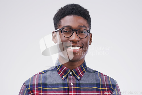 Image of Smile, portrait of black man with glasses and happy against a white background. Nerd or geek, happiness and African male smiling with proud facial expression against a studio backdrop for confidence
