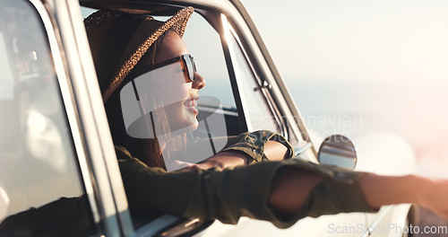 Image of Road trip, window and happy with a woman in a car for travel, freedom or a joy ride as a tourist on the coast. Nature, sunset and relax with a young female traveler taking a drive for adventure