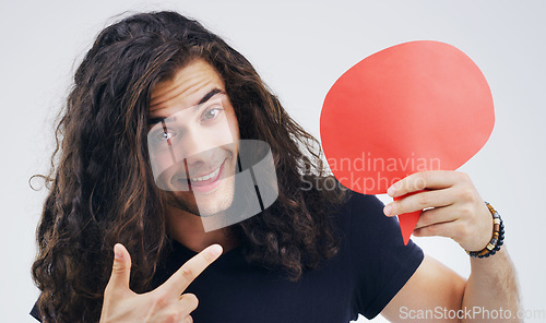 Image of Man, speech bubble and pointing in studio portrait for smile, opinion or social media by white background. Gen z guy, poster or paper sign for vote, review or mockup with point for idea, news or chat