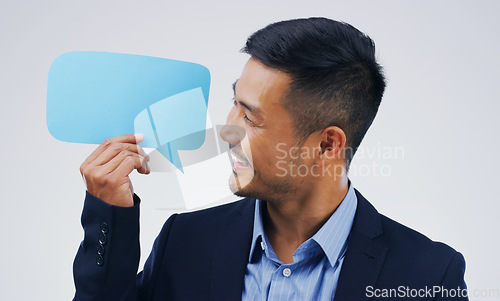 Image of Asian business man, speech bubble and studio with smile, opinion or social media with by background. Businessman, poster or paper sign for vote, review or mockup with happiness for idea, news or chat