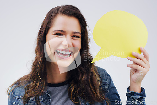 Image of Happy woman, portrait smile and speech bubble in social media, question or FAQ against a white studio background. Female person smiling with shape, symbol or sign for comment, message or mockup space