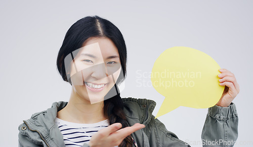Image of Happy asian woman, portrait smile and speech bubble for question, FAQ or social media against a white studio background. Excited female person smiling with sign for comment, message or mockup space