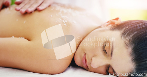 Image of Spa, relax and woman doing back scrub skincare as self love, cosmetic and luxury stress relief with salt for the body. Massage, beauty and person in a dermatology salon to exfoliate for wellness