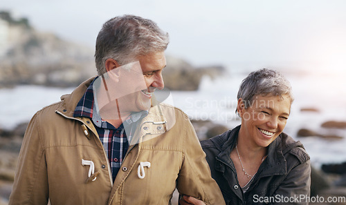 Image of Senior couple, laugh and beach walk outdoor with smile from marriage and love. Happy, elderly people and bonding by a ocean and sea on holiday with travel and walking on vacation in retirement