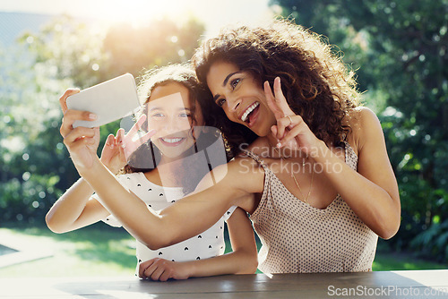 Image of Mom, girl kid and selfie in garden with peace sign, happiness or smile in summer sunshine. Young mother, daughter and profile picture for social media, app or blog in backyard with bond, love or care