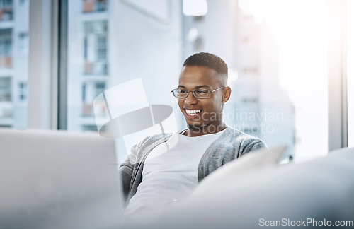 Image of Home, man and laptop working on sofa or elearning, remote study or distance learning and online studying with internet communication. Black student, happy on computer in apartment or living room