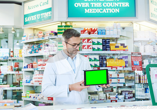 Image of Man, pharmacist and tablet with green screen with health, store and mockup with pharmaceutical promo on app. Mature pharma expert, digital touchscreen and space with chromakey for mock up in shop