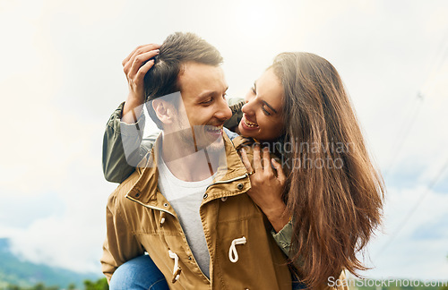 Image of Playful, love and piggyback with couple in nature for weekend, smile and bonding. Happiness, relax and care with man carrying woman on countryside date for spring, vacation and travel