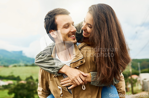 Image of Date, love and piggyback with couple in nature for happy, smile and bonding. Happiness, relax and care with man carrying woman in countryside field for spring, anniversary vacation and travel