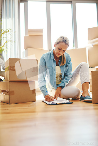 Image of Woman, boxes and sign paperwork in the living room for investment with a contract. Investing, document and writing on the floor with a lease at a new home for retirement and finance for savings.