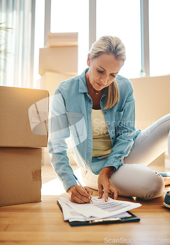 Image of Paperwork, boxes and woman on the floor in apartment for growth on investment in mortgage. New house, document and sign for lease agreement for home insurance in title and for savings and finance.
