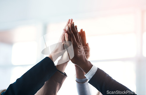 Image of High five, colleagues and their hands together for their achievement with lens flare. Collaboration or team, group of businesspeople for support and friends with hand for cooperation or goal