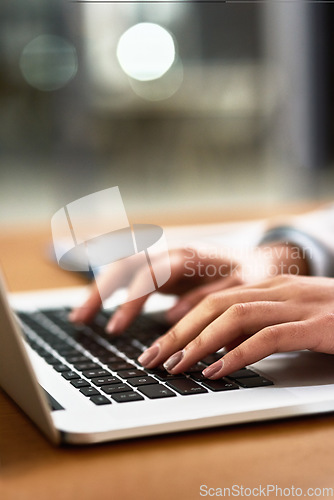 Image of Laptop, keyboard and hands of a person at desk for work, internet and connection at night. Business, closeup and a secretary or receptionist typing on a computer for late admin online in an office