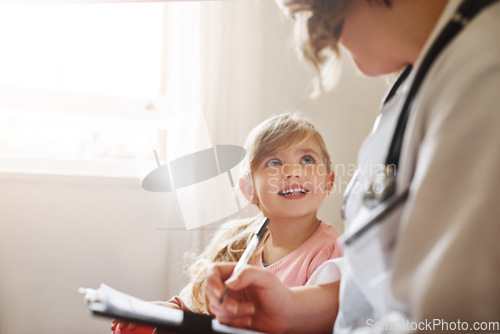 Image of Child, family doctor and pediatrician talking with medical checklist in hospital for wellness. Happiness, clinic consultant and professional with healthcare and kids appointment with consulting form