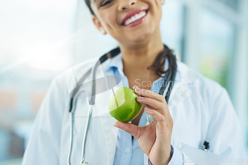 Image of Hands, doctor and smile of woman with apple for nutrition, healthy diet and wellness. Medical professional, nutritionist and fruit for vitamin c, healthcare or natural food for vegan health benefits