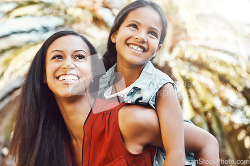 Image of Happy, outdoor and mother giving her child piggyback ride in the garden of the backyard of their home. Happiness, smile and young woman or mom playing and having fun with her girl kid at family house