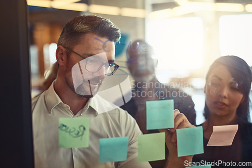 Image of Businessman, writing and team planning in strategy, brainstorming or schedule tasks at the office. Man DEO in leadership, presentation or training staff in project plan or meeting at workplace