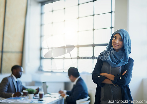 Image of Business woman, muslim and arms crossed portrait in an office with a smile for career pride. Arab female entrepreneur or leader at a diversity and corporate workplace with a positive mindset