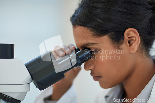 Image of Science, analysis and scientist with a microscope in lab for discovery, experiment or project. Medical research, biotechnology and woman researcher working with equipment in pharmaceutical laboratory