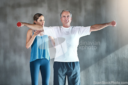 Image of Physical therapy, dumbbell and fitness with old man and personal trainer for support, health and physiotherapy. Training, weightlifting and coaching with senior patient and female trainer for help