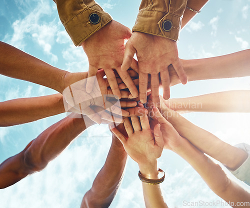 Image of Bottom, people and hands in support of collaboration, trust or solidarity on blue sky background. Teamwork, friends and low angle hand of person group outdoor for team building, partnership or goal