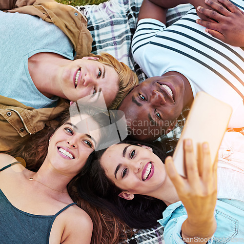 Image of Friends, top view and outdoor for circle selfie, happiness and diversity for social media post, app or blog. Men, woman and youth for photography, profile picture and bonding while lying on ground