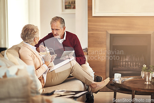 Image of Finance, tablet and budget with an old couple in a home for debt, retirement or pension planning. Accounting, money or investment with a senior man and woman in their house for financial insurance