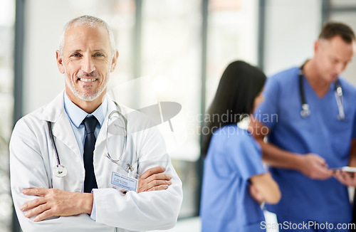 Image of Healthcare, smile and portrait of senior doctor with arms crossed, pride and support in hospital. Health care, happiness and expert medicine, confident and happy man, medical professional in clinic.