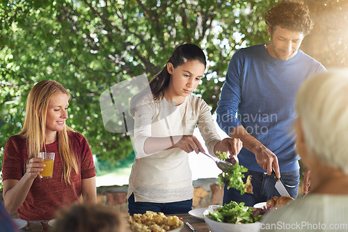 Image of Food, salad and help with family at lunch in nature for health, bonding and celebration. Vacation, barbecue and event with parents and children eating together for garden, generations and wellness