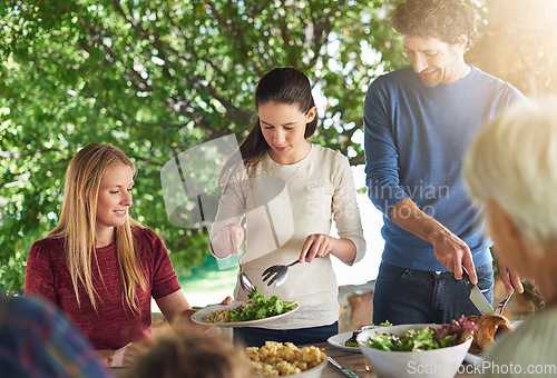 Image of Food, salad and share with family at lunch in nature for health, bonding and celebration. Vacation, social and event with parents and children eating together for dining, generations and wellness