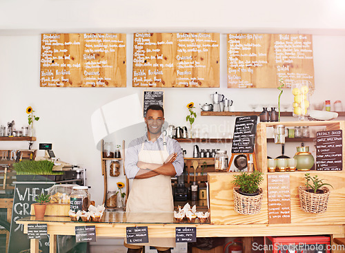 Image of Black man, portrait and owner with arms crossed in cafe with pride for career or job. Barista, smile and confidence of African person from Nigeria in restaurant, small business and coffee shop.