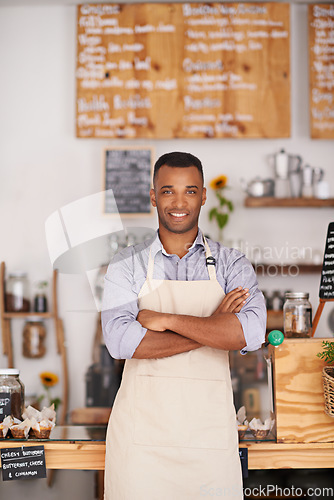 Image of Black man, portrait smile and waiter with arms crossed in cafe with pride for owner career. Barista, happy and confidence of African person from Nigeria in restaurant, small business and coffee shop