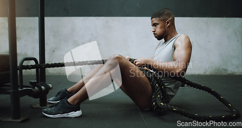 Image of Health, fitness and man with weight sled at gym for training, power and intense cardio on wall background. Performance, endurance and male person with rope for strong, muscle or core workout on floor