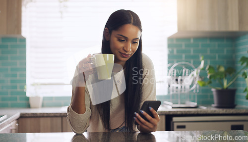 Image of Reading, phone and woman with coffee in a kitchen relax with social media, app or texting. Smartphone, streaming and female drinking tea in her home on day off, calm and peaceful in her apartment