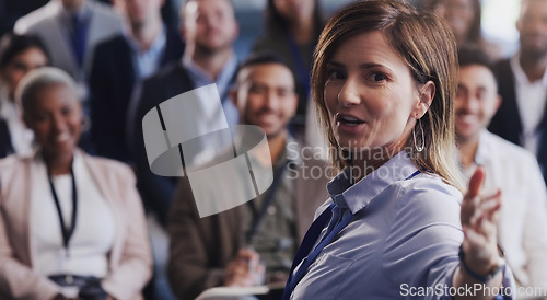 Image of Business woman, presentation and a speaker with audience at a seminar, workshop or training. Portrait of a presenter speaking to diversity men and women crowd at a conference for corporate education