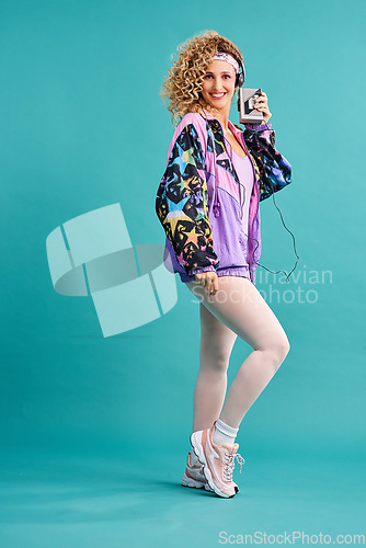 Image of 80s fitness, retro and woman portrait with vintage, neon and style in a studio. Blue background, female person and cassette player of a model with workout, fashion and training outfit with a smile