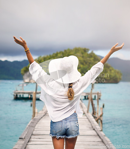 Image of Island, travel and back of woman on deck for holiday, summer vacation and weekend in Maldives. Traveling, tropical ocean and female person on luxury resort for relaxing, happiness and adventure