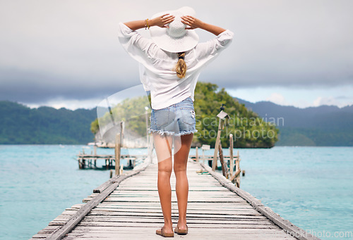 Image of Travel, ocean and back of woman on island deck for holiday, summer vacation and weekend in Maldives. Traveling, tropical villa and female person on luxury resort for relaxing, freedom and adventure