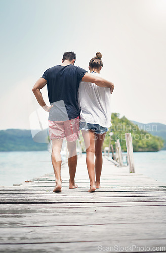 Image of Couple, walking and beach deck on holiday with freedom and love in summer in Thailand. Tropical nature, sea and back of people on a boardwalk walk in the sun on vacation break by the ocean and water
