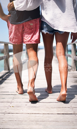 Image of Travel, island and couple walking on deck for holiday, summer vacation and weekend in Maldives. Love, tropical and legs of man and woman on luxury resort for honeymoon, anniversary and adventure