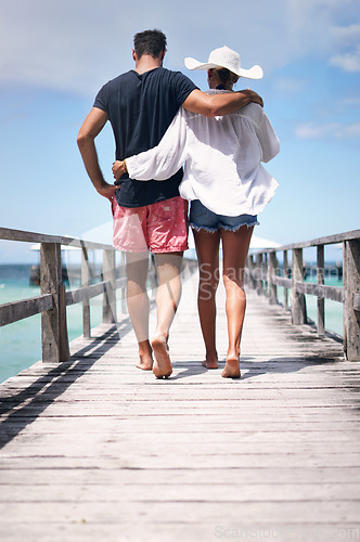 Image of Couple legs, walking and beach deck on a tropical island on vacation with freedom by sea. Ocean, relax and walk of a man back and woman together with love in summer on a holiday outdoor in sun