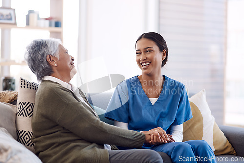 Image of Consulting, caregiver and elderly woman laughing on sofa and holding hands in home living room. Support or healthcare, happy and female nurse talking or communication with senior citizen on a couch